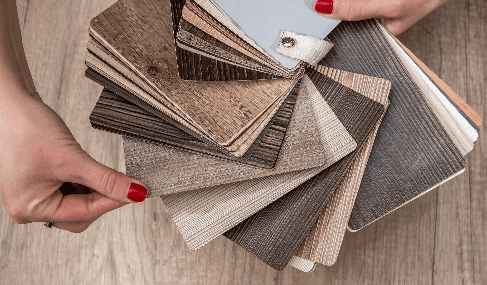 hands choosing the right vinyl flooring for a home